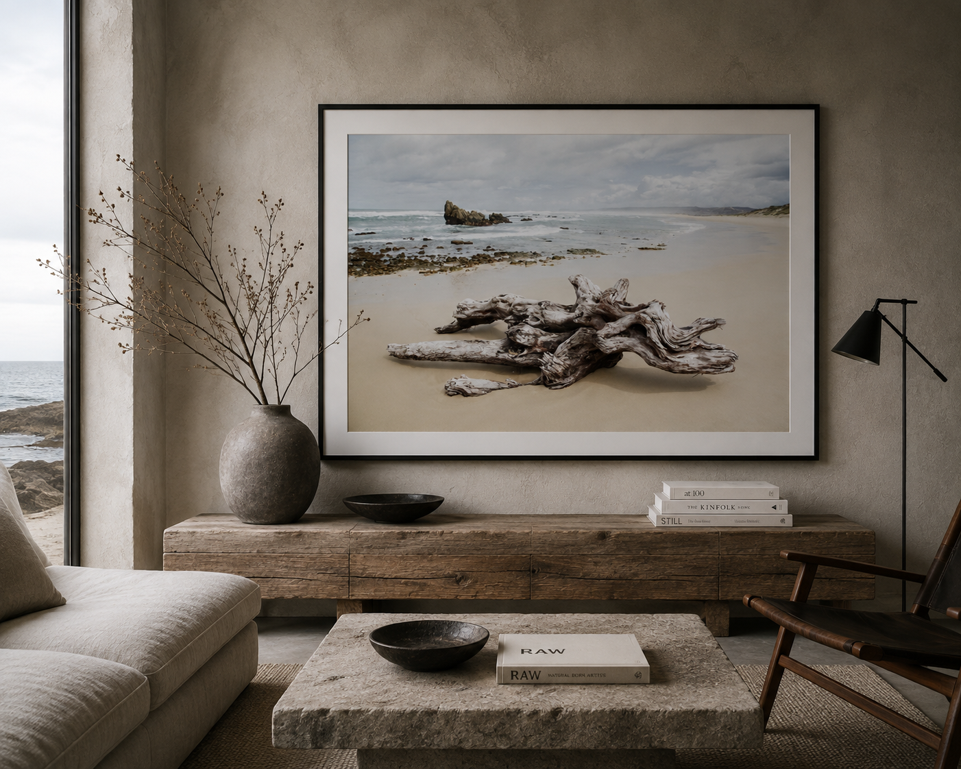 Framed fine art print of driftwood on a South African beach by Richard du Toit, displayed in a relaxed coastal interior